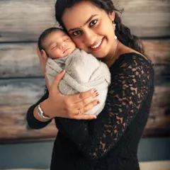 The purest love. In this simple, intimate portrait, a mother holds her newborn for the first time. I focus on capturing that immediate, powerful connection and the peaceful expression of a baby feeling safe and loved.