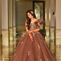 A beautiful engagement look in a brown gown. The soft curls and glowing makeup create a romantic and elegant style for her special evening.
