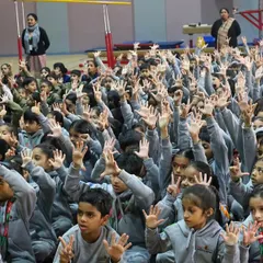 Look at all those hands in the air. This is what active participation looks like. During a winter morning session at Suncity School, the students were so engaged, singing along and eager to be part of the story.