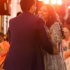 The couple's first dance as an engaged pair. I use the warm stage lighting to capture the joy and romance of this celebratory moment.