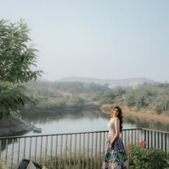 A beautiful portrait of the bride on a scenic deck. The wide-angle shot captures both her elegance and the stunning natural landscape of the venue.