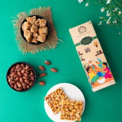A vibrant, high-contrast flat lay like this one for peanut chikki makes the product jump off the screen. The green background complements the earthy tones of the peanuts and jaggery, creating a visually appealing shot for social media.