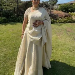 The full look is one of understated elegance. The ivory outfit is timeless, and the makeup is kept soft and natural to match.