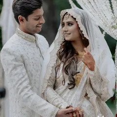 An intimate Nikah ceremony at Farmhouse Collective. The couple shares a look of love, framed by elegant white drapes that complement their beautiful attire.