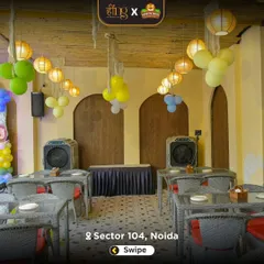 The outdoor covered dining area set up for a party. The space is versatile and can be arranged to accommodate buffet lines and guest seating for events of all sizes.