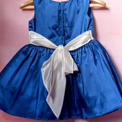 The back of a dress is just as important as the front. I love finishing my designs with a beautiful, oversized bow, like this white one on a royal blue satin dress.