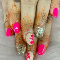 When you want your nails to be as vibrant as the celebration. This set combines hot pink polish with gold glitter accents and 3D heart art, creating a bold and festive look that stands out beautifully against henna.