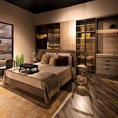 This premium bedroom setting is finished in warm, neutral tones using a combination of succupira veneer and brass matt highlights. The leather upholstery on the bed and study chair adds a layer of timeless sophistication to the cozy environment.