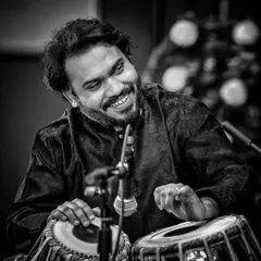 A moment of joy during a concert, captured in black and white. A smile shared with a fellow artist or the audience is a beautiful part of any performance.