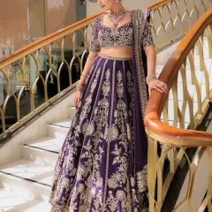 A full-length view of this magnificent deep purple lehenga by Ridhi Mehra. The intricate silver embroidery stands out beautifully, and the classic silhouette is perfect for a bride who wants a regal and timeless wedding day look.