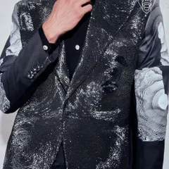 A detail of the Molten Metallic blazer, where hand-beading creates a liquid-metal effect that moves with light. This piece represents my more experimental, avant-garde approach to formalwear, designed for making a powerful impact.