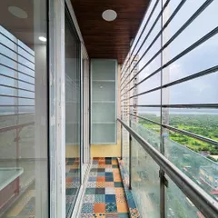 Another view of the balcony, showing a slim storage cabinet and a wooden ceiling panel, which adds warmth and a finished look to the space.