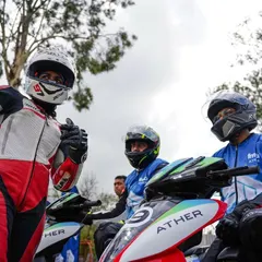 A moment of camaraderie between riders before the start of an EV race. Our events bring together professionals and amateurs who share a passion for motorsport.