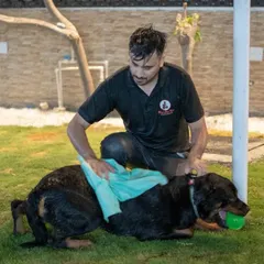 Even after playtime, we make sure our guests are comfortable. Here, a staff member gently dries off a happy Rottweiler after his swim.