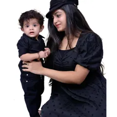 A mother and her young son in matching black outfits. The studio setting allows for clean, focused portraits that highlight your connection without any distractions.