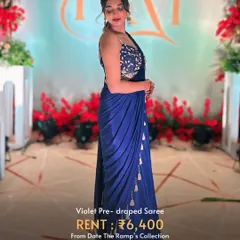 A violet pre-draped saree that combines the elegance of a saree with the ease of a gown. Perfect for a cocktail party.