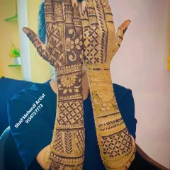 This back-of-hand design covers the entire area up to the forearm with a mix of floral bands and geometric check patterns.