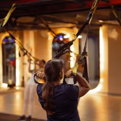 A client performs a TRX row, an essential exercise for building a strong back and improving posture. We focus on controlled movements to ensure maximum muscle engagement.