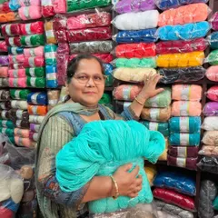 I feel so happy when I am surrounded by colorful yarn. Here I am, shopping for a new project. I am holding a big bundle of my favorite turquoise color.