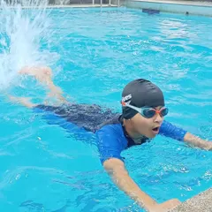 Practicing arm movements by the pool edge is a core part of my beginner curriculum to build muscle memory.