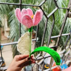 A single, fully bloomed pink crochet tulip. I designed this with open petals to give it a delicate and realistic look. It's a beautiful piece of home decor.