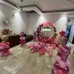 Here is a wider view of the pink-themed welcome home decoration, showing how the setup can transform an entire room corner into a perfect photo zone.