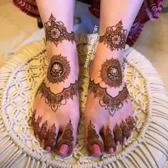 The completed lotus mandala design with a rich, dark henna stain, ready for a special occasion.