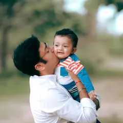 A father's gentle kiss for his son during their family portrait session. I focus on capturing these small, affectionate gestures that tell the story of your family's love.