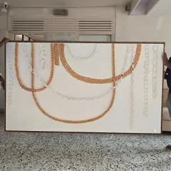 This large-scale 3D chain artwork is being delivered to a client. This piece was a significant commission that involved creating various chain styles with air-drying clay, painted in gold and white.