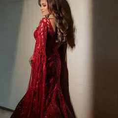 Draped in ruby red and detailed with artistry, this fully embellished lehenga features floor-sweeping sleeves and my signature cutwork embroidery.