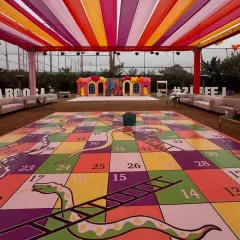 Our giant game rentals are perfect for getting everyone involved, from kids to adults. This oversized Snakes and Ladders board was a huge hit at a pre-wedding game night, providing hours of interactive fun for all the guests.