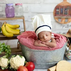 A close-up of our master chef, peacefully dreaming of their next culinary creation. I love styling these detailed, imaginative scenes for your baby's first photoshoot.