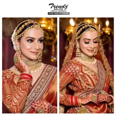 This is a classic and regal bridal look. The makeup is perfected with dramatic winged eyeliner, a traditional bindi, and beautifully defined features, paired with an ornate matha patti for a timeless appeal.
