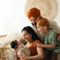 A candid moment of joy as a family welcomes their newest member. Capturing the interaction between parents, a new baby, and an older sibling is always special.