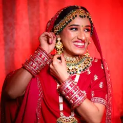A candid moment of happiness. Her makeup features a warm, glowing base and beautifully defined eyes, designed to look stunning both in person and in photographs.