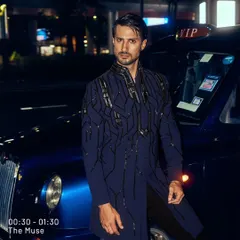 I designed this piece for the man who owns the night. The deep blue fabric is structured with architectural, hand-embroidered patterns, creating a look of unapologetic power. It is a modern statement for a cocktail event or a grand reception.