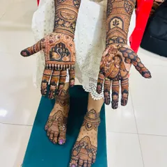 This is a full bridal mehendi package, with coordinated designs for hands and feet. The design combines personal elements like Radha Krishna portraits with classic motifs like swans and lotuses for a timeless look.