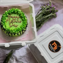 This vibrant green bento cake comes with a "Happy Mother's Day" topper and a chocolate drip effect, showing the variety of designs we can create even on a small cake.