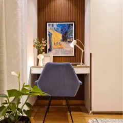 This home office setup was tucked into a corner of the master bedroom. I created a floating desk from the client's old table and set it against a fluted wood accent wall. The result is a seamless and stylish workspace that blends right in.