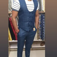 This client is wearing a custom made two piece set with a double breasted waistcoat and matching trousers in a blue check fabric. It's a modern way to wear a waistcoat.