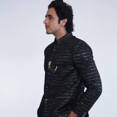A side profile of our black striped bandhgala jacket. The subtle shimmer and sharp tailoring make it a sophisticated choice for any formal event.