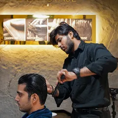 It's all in the details. Here, one of our expert stylists focuses on creating clean lines and perfect texture for a classic men's haircut, using premium Kérastase products for a flawless finish.