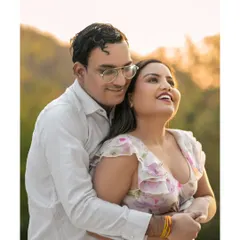 A close-up filled with pure happiness, bathed in the warm, golden light of the setting sun. This candid shot captures the genuine joy and love that radiates from the couple.