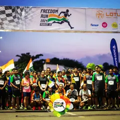 The starting line of the Freedom Run, buzzing with anticipation and energy. Runners of all ages and abilities gather to start the race together.