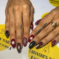 A retro and fun set inspired by Coca-Cola. I combined the iconic logo on a chrome nail with bold red, stars, and graphic black and white swirls for a pop-art vibe.