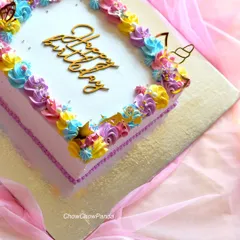 A corner detail of the unicorn sheet cake, showing the gold unicorn horn and butterfly toppers.