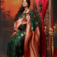 The Indian look is one of the best for a maternity shoot. This mom-to-be looks absolutely divine in a dark green silk saree with a red border, exuding grace and tradition.