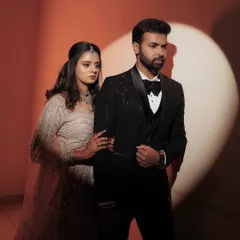 A stylish, cinematic portrait of the couple at their reception, using a spotlight to create a dramatic and modern effect.
