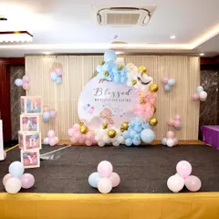A wider view of the "Blessed Beyond Measure" baby shower stage, showing the backdrop, balloon arrangements, and decorative "BABY" blocks.