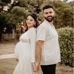 Capturing the quiet joy and connection between partners is one of my favorite things. This outdoor couple's portrait, shot in soft natural light, is all about the love and anticipation you share.